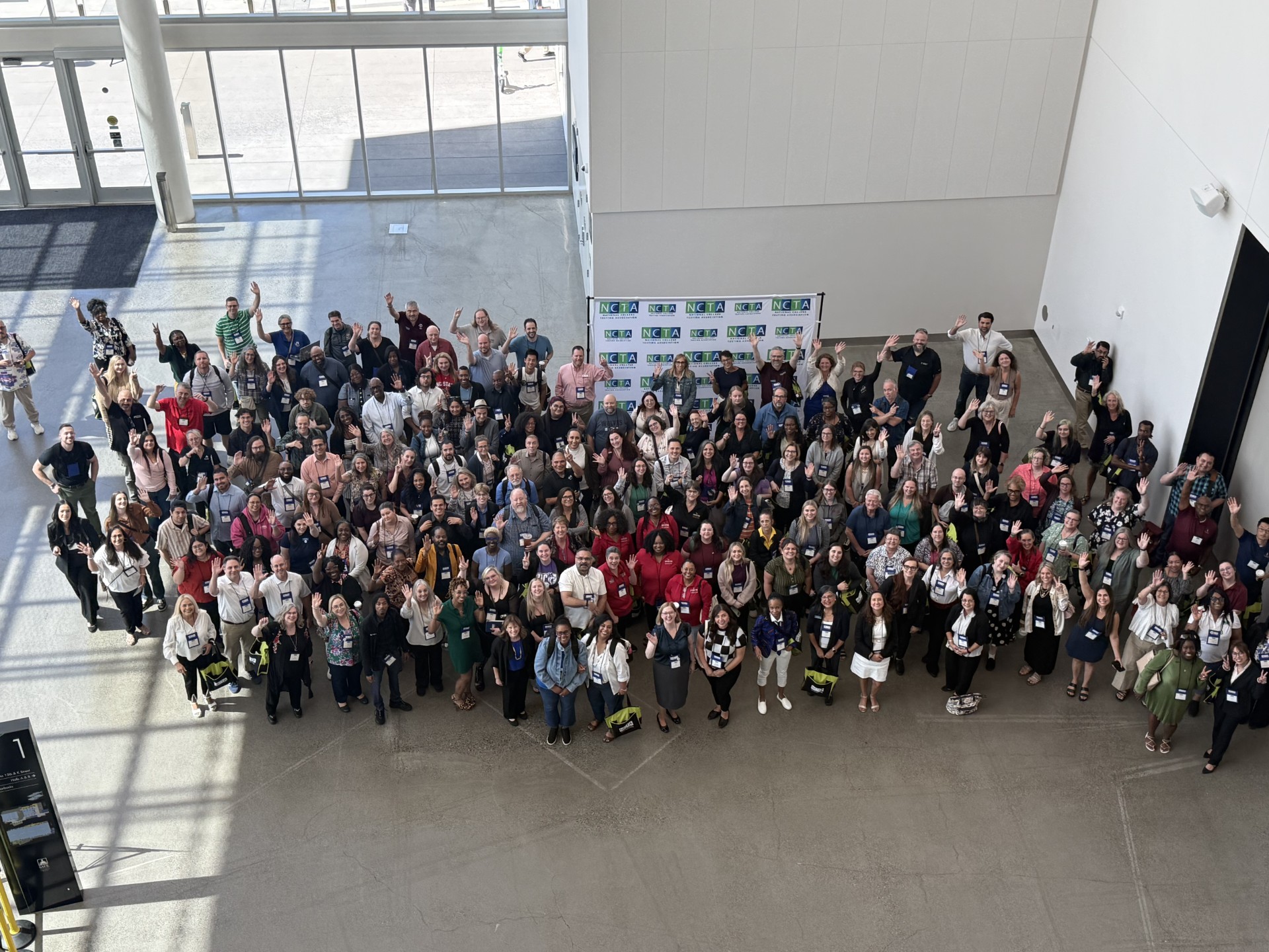 Large group of attendees waving at the 27th Annual NCTA Conference in Sacramento, California.